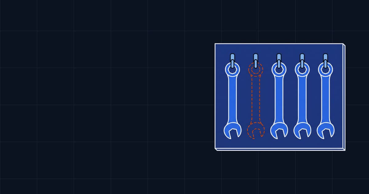 A shadow board of spanners with one position empty, its painted outline still on the board.